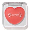 Heart-shaped Baby Bunny ColourPop Lip and Cheek Balm shown closed in a clear square compact, coral-pink tint with white sparkle graphics and ColourPop logo, displayed under studio light on a white background.