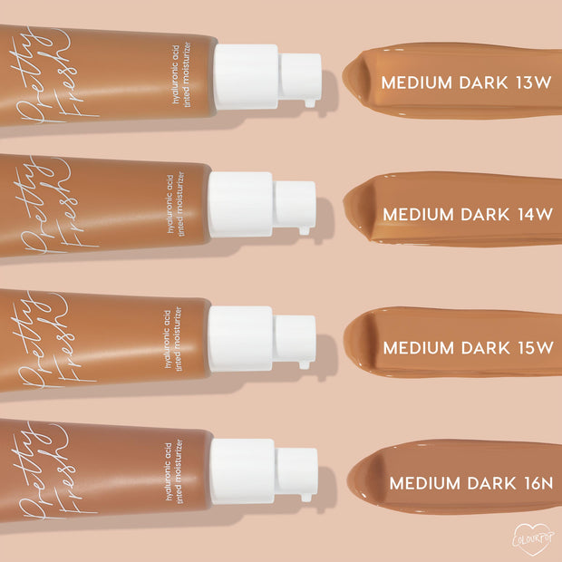 ColourPop Pretty Fresh Tinted Moisturizer, shade Medium Dark 14W, swatched alongside Medium Dark 13W, 15W, and 16N; four tan pump bottles line up horizontally with creamy swipes on a beige background.