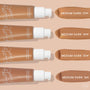 ColourPop Pretty Fresh Tinted Moisturizer, shade Medium Dark 14W, swatched alongside Medium Dark 13W, 15W, and 16N; four tan pump bottles line up horizontally with creamy swipes on a beige background.