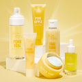 Pore Real Cleanser foaming face cleanser by ColourPop Fourth Ray Beauty stands center-left with a white pump, displayed beside Pineapple Face Polish, Fine Tune pore tonic, Super Fine mask, and Remedy serum on a bright yellow studio backdrop.