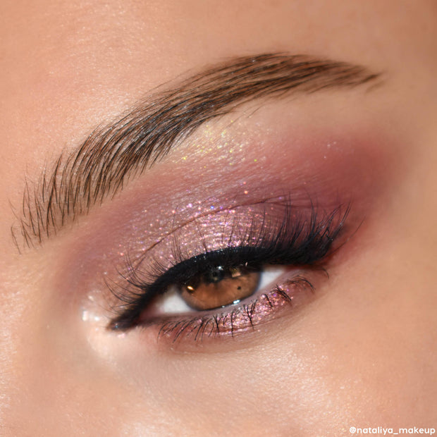 Shimmering eyelid displays mauve-to-rose gold glitter from the After Hours ColourPop Shadow Palette, blended with deep plum at the outer corner and finished with sleek black liner and voluminous lashes in a close-up evening eye look.
