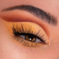Warm honey-gold shimmer lids with a burnt orange crease and long lashes showcase the Sweet As Can Bee ColourPop Shadow Palette, a shadow palette, in a close-up of a brown eye with defined brow, highlighting rich pigment and metallic finish.