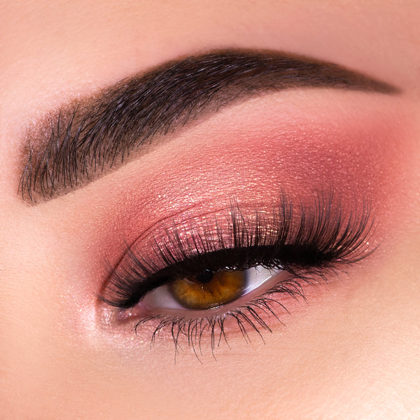 Shimmery rose-gold eyelid showcases blended pink and mauve shades from the Blush Crush Shadow Palette, framed by bold black liner and wispy lashes beneath a groomed brow - an on-eye look featuring a ColourPop Shadow Palette.