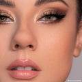 Close-up eyes wearing shimmering gold and warm brown smoky look created with 11:11 ColourPop Shadow Palette, featuring metallic lids, bright inner-corner highlight, black winged liner, full lashes, and nude glossy lips in studio lighting.
