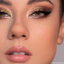 Close-up eyes wearing shimmering gold and warm brown smoky look created with 11:11 ColourPop Shadow Palette, featuring metallic lids, bright inner-corner highlight, black winged liner, full lashes, and nude glossy lips in studio lighting.