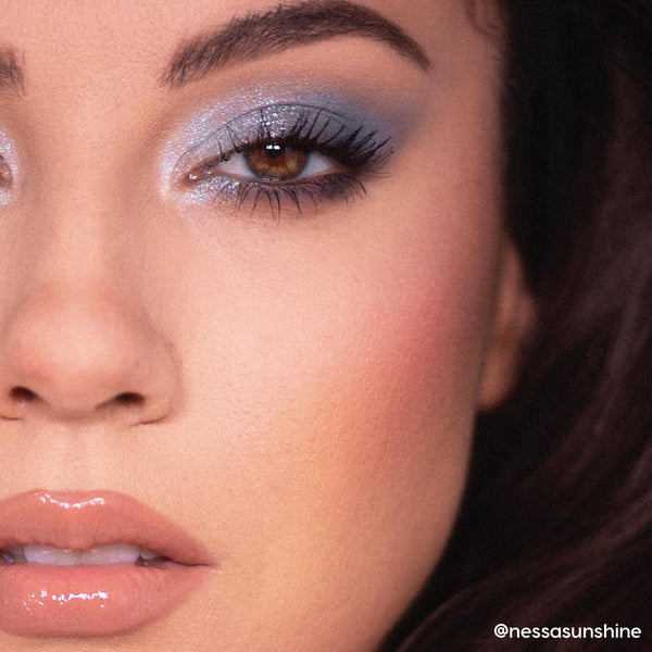 So Elemental ColourPop Shadow Palette creating a cool-toned, shimmery blue smoky eye with inner-corner highlight and lengthened lashes, shown in a close-up of a person’s eye and nude glossy lips under soft studio lighting.
