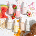 Watermelon Face Milk bottle with dropper stands center-left, labeled Fourth Ray, surrounded by fresh watermelon slices, strawberries, rose petals, oats, turmeric, coconut, and sister variants - a ColourPop Face Milk skincare flat lay for dewy hydration.