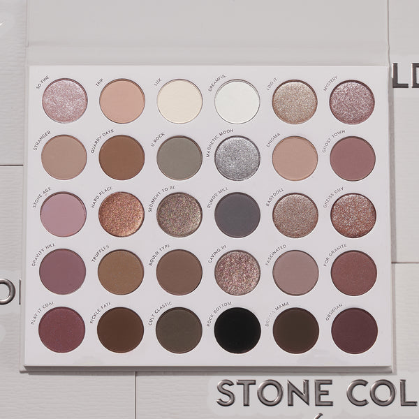 Bold + Bare ColourPop Shadow Palette Set presents an open 30-pan cool‑toned eyeshadow palette with matte and shimmer taupes, mauves, grays, silvers, plum and black, arranged in neat rows on a white tray, lid open on a light textured surface.