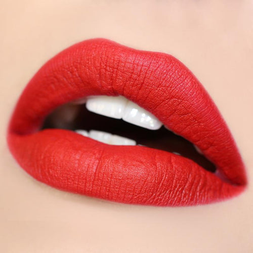 Bold red lips wearing Trust Me Lippie Stix, a matte true-red from ColourPop Lippie Stix, delivering full-coverage color with a velvety finish; close-up shows crisp edges and smooth texture against neutral skin.