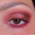 Shimmer wine-toned eyeshadow shades from ColourPop Wine and Only shadow palette blend across a brown eye, with cranberry shimmer on the lid, matte burgundy smoked on the outer corner and lower lash line, close-up makeup look.