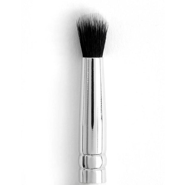 ColourPop Small Tapered Brush blending and buffing eye makeup, shown close-up on a white background with a short polished silver handle and soft tapered black-and-white bristles, ideal for precision crease and concealer work.