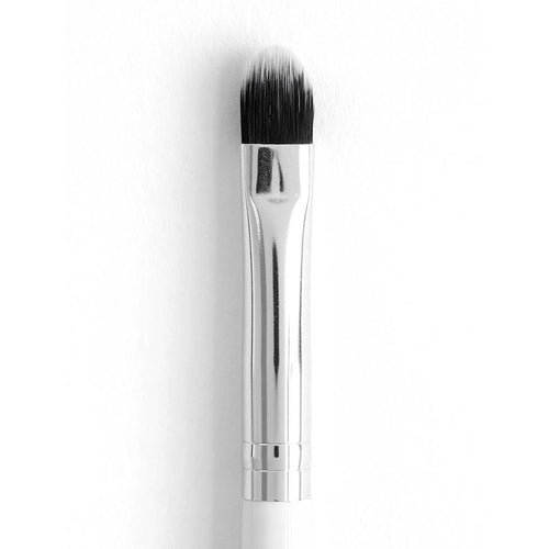 ColourPop Small Shader makeup brush packing and blending eyeshadow with dense rounded synthetic bristles, a polished silver ferrule, and a white handle, shown close-up against a clean white background.