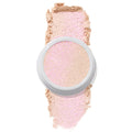 ColourPop Felicity Super Shock Highlighter displays a champagne, pink-shift shade in a white pot, the cream-to-powder formula catching light over a matching soft swatch on a clean white background.