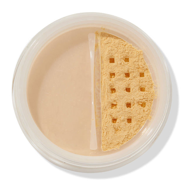 ColourPop No Filter Loose Setting Powder in Banana shown open, yellow-toned powder visible through a square-holed sifter in a clear round jar on a white background, used for brightening and setting makeup.