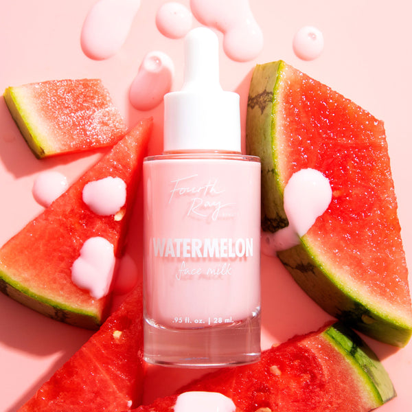 Pink dropper bottle of Fourth Ray Beauty Watermelon Face Milk standing amid fresh watermelon slices, creamy pink formula dripped on a blush background; a hydrating 0.95 fl oz ColourPop Face Milk with a juicy, summery skincare vibe.