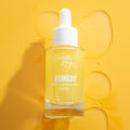 Remedy 10% Niacinamide Serum bottle standing upright with a white dropper cap, filled with bright yellow liquid, on a sunny yellow background with glossy serum drops - ColourPop Face Serum by Fourth Ray Beauty, 0.95 fl oz (28 ml).