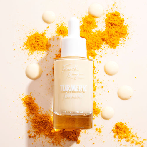Fourth Ray Beauty Turmeric Face Milk dropper bottle with white cap stands upright, 0.95 fl oz/28 mL, filled with pale yellow serum, surrounded by creamy droplets and bright orange turmeric powder on a light backdrop, featuring ColourPop Face Milk skincare.