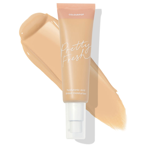 ColourPop Pretty Fresh Tinted Moisturizer in Light 7 W dispenses from a pump tube, shown over a beige swatch to display shade; hyaluronic acid formula with peach-and-nude packaging on a clean white background.