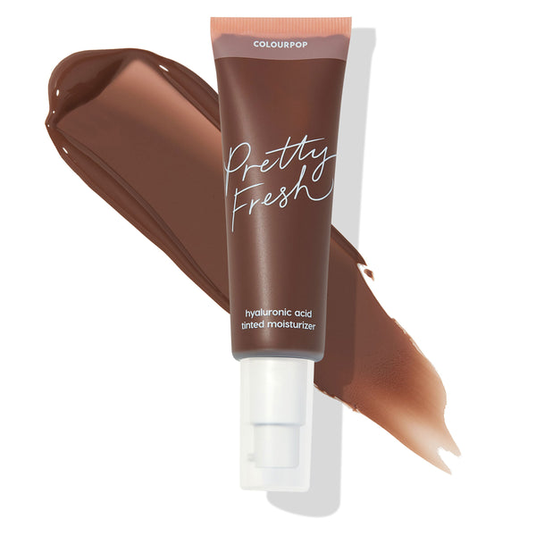 ColourPop Pretty Fresh Tinted Moisturizer, shade Deep Dark 23 N, sits over a wide swatch showing its deep neutral color; a brown tube with white pump and Pretty Fresh script promotes the hyaluronic acid formula against a clean white background.