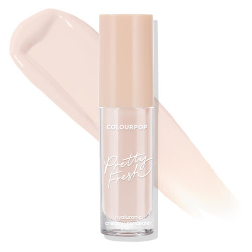 ColourPop Pretty Fresh Creamy Concealer in Fair 10 N stands upright with a beige cap and clear tube, branding visible, as a light neutral swatch sweeps behind on a clean white background.