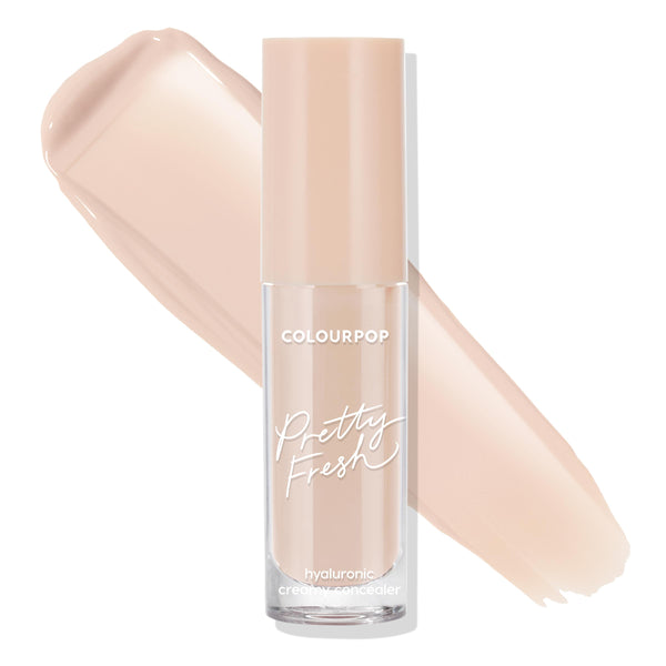 ColourPop Pretty Fresh Creamy Concealer in Light 40 N stands upright in a clear frosted tube with a beige cap, hyaluronic creamy formula visible, shown with two light neutral swatches sweeping across a white background.
