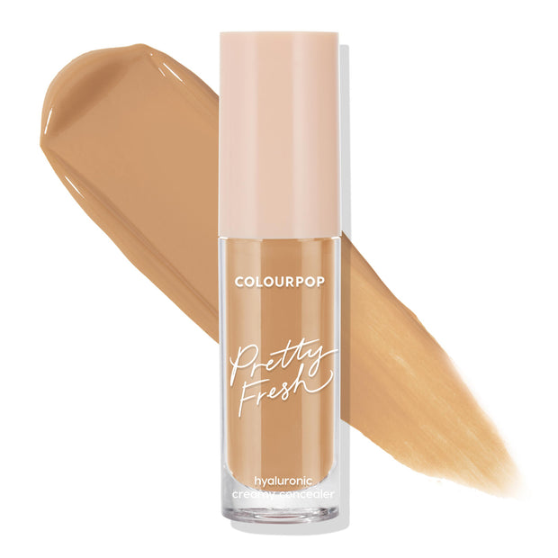 ColourPop Pretty Fresh Creamy Concealer in Medium Dark 145 W stands upright with a blush cap, its hyaluronic formula displayed in two warm medium-dark swatches on a white background, showcasing coverage and shade.