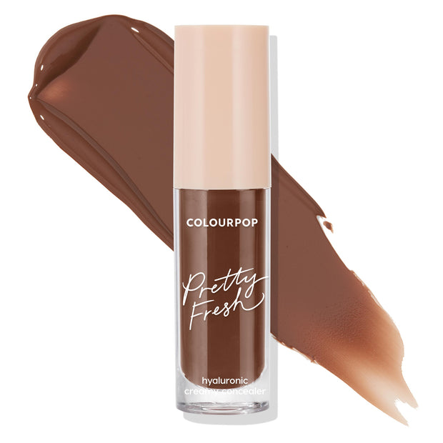 ColourPop Pretty Fresh Creamy Concealer in Deep Dark 205 N stands upright with a pale beige cap, a clear tube, and rich chocolate-brown pigment swatched behind it, highlighting the hyaluronic creamy formula on a clean white background.