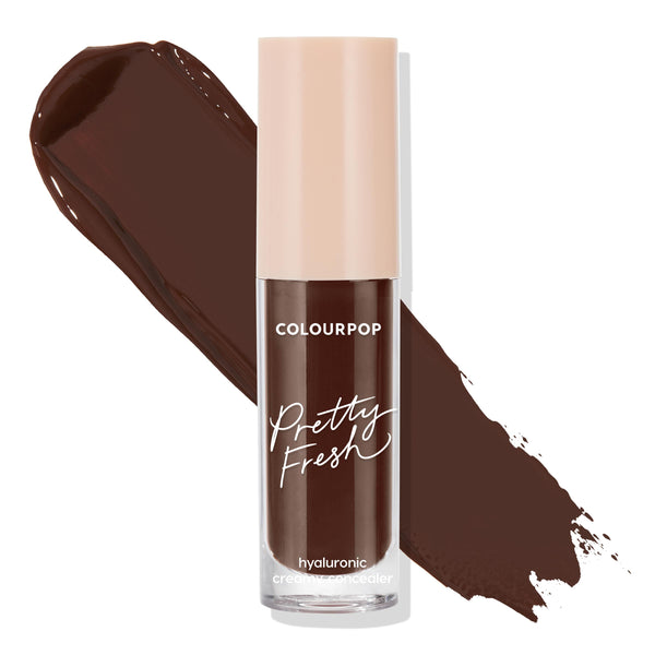 ColourPop Pretty Fresh Creamy Concealer in Deep Dark 220 C stands upright with a rich deep-brown swatch behind it on a white background, showcasing a clear tube, beige cap, and hydrating hyaluronic formula.