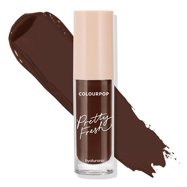 ColourPop Pretty Fresh Creamy Concealer in Deep Dark 220 C stands upright with a rich deep-brown swatch behind it on a white background, showcasing a clear tube, beige cap, and hydrating hyaluronic formula.