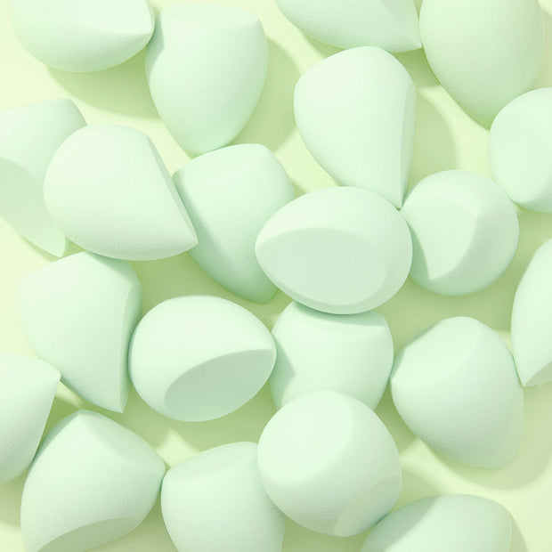 Complexion Blending Sponge set scattered across a pale mint background, mint green teardrop sponges with flat edges and rounded tips, soft foam for seamless foundation blending; ColourPop Makeup Tools & Accessories.