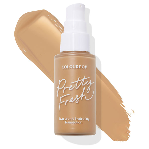 ColourPop Hyaluronic Hydrating Foundation in Medium Dark 135 W, a frosted bottle with a white pump and Pretty Fresh branding, stands before a tan swatch on a white background, showing the shade and creamy liquid texture.