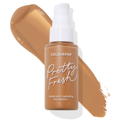 ColourPop Hyaluronic Hydrating Foundation Pretty Fresh bottle in shade Dark 155 W, standing upright with a white pump and frosted tan bottle, set over a wide caramel-brown swatch that highlights its warm undertone on a clean white background.