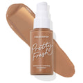 ColourPop Pretty Fresh Hyaluronic Hydrating Foundation bottle with white pump in shade Dark 175 W, placed over a smooth swatch of warm deep-brown tone, showcasing the ColourPop Hyaluronic Hydrating Foundation for deep complexions.