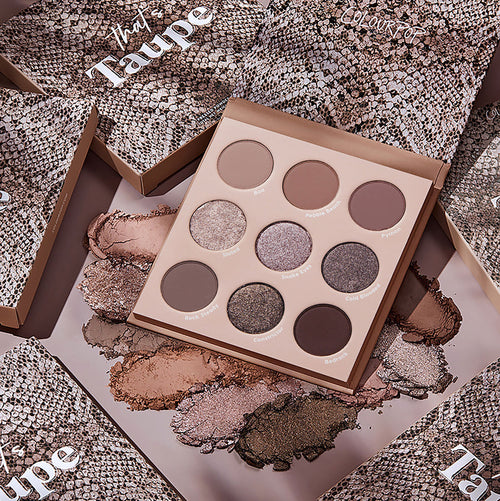 Open That’s Taupe ColourPop Shadow Palette showcasing nine cool taupe neutrals in matte and metallic finishes - pans labeled Slated, Snake Eyes, and Bedrock - surrounded by powder swatches and snake‑print boxes.