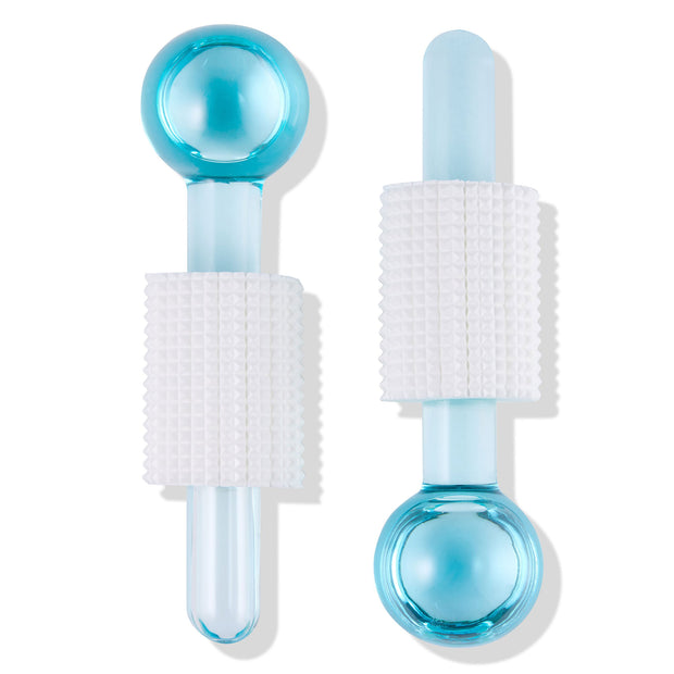 Blue glass Cooling Facial Globes with white textured silicone grips rest side by side on a white background, used for de-puffing and soothing facial massage; a sleek addition to ColourPop Skincare Tools And Accessories.