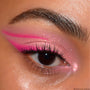 Shimmery pink eye makeup showcases ColourPop Sweet Tea Super Shock Shadow swept across the lid, with a bold hot-pink graphic wing and glittery finish, shown in a close-up of one eye to highlight sparkle and color payoff.