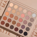 Shadow palette opens to reveal 30 all‑matte neutral shades - ivory, peach, taupe, mauve, brown, gray, and black - arranged in a 6x5 grid inside a beige case on a nude backdrop; ColourPop Gone Matte shadow palette for everyday eye looks.