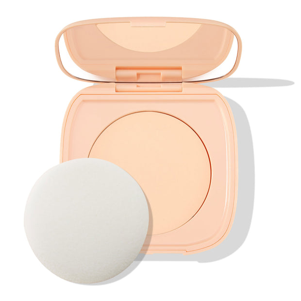 Open peach flip-top compact displaying ColourPop Pretty Fresh Face Powder in shade Fair 1, a light fair pressed powder, with a round white applicator sponge beside the pan on a clean white background.