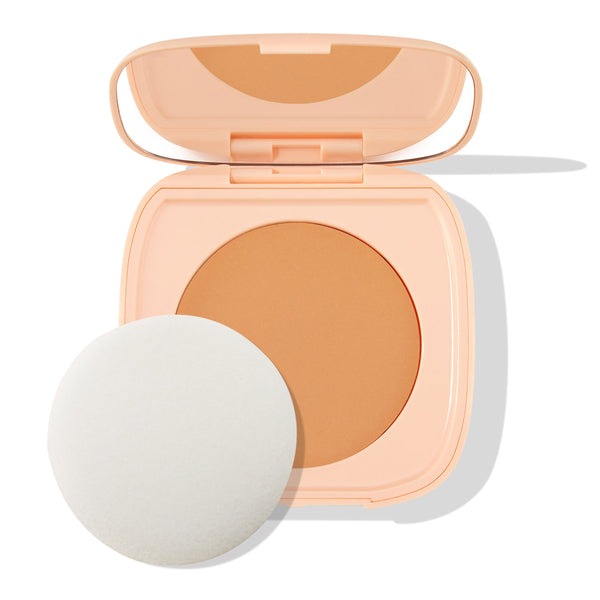 ColourPop Pretty Fresh Face Powder in Medium 12 sits open, revealing a medium-tan pressed powder pan and mirror in a peach compact, with a white round applicator sponge beside it on a clean white background.