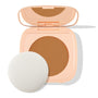 Open peach compact displays ColourPop Pretty Fresh Face Powder in Dark 18, a pressed powder pan with built-in mirror and round applicator sponge on a white background.