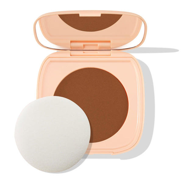 Open peach square compact displays the Deep Dark 21 shade - a rich deep-brown pressed pan - with a built-in mirror and round white puff beside it on a white backdrop; ColourPop Pretty Fresh Face Powder.