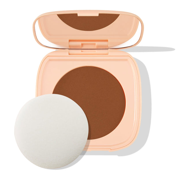 Open peach square compact displays the Deep Dark 21 shade - a rich deep-brown pressed pan - with a built-in mirror and round white puff beside it on a white backdrop; ColourPop Pretty Fresh Face Powder.