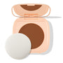 Open peach square compact displays the Deep Dark 21 shade - a rich deep-brown pressed pan - with a built-in mirror and round white puff beside it on a white backdrop; ColourPop Pretty Fresh Face Powder.