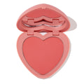 Heart-shaped pink compact sits open to reveal Let’s Dance ColourPop Pressed Powder Blush, a soft coral pan with inner mirror, presented on a clean white background.