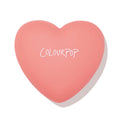 Heart-shaped coral compact with ColourPop logo, presenting Let’s Dance, a ColourPop Pressed Powder Blush, closed and centered on a white background.