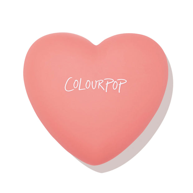 Heart-shaped coral compact with ColourPop logo, presenting Let’s Dance, a ColourPop Pressed Powder Blush, closed and centered on a white background.