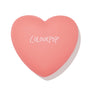 Heart-shaped coral compact with ColourPop logo, presenting Let’s Dance, a ColourPop Pressed Powder Blush, closed and centered on a white background.