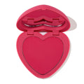Heart-shaped Text Me pressed powder blush in a bright pink compact, opened to show the vibrant fuchsia pan and lip-shaped mirror, ColourPop Pressed Powder Blush for cheeks displayed on a white background.