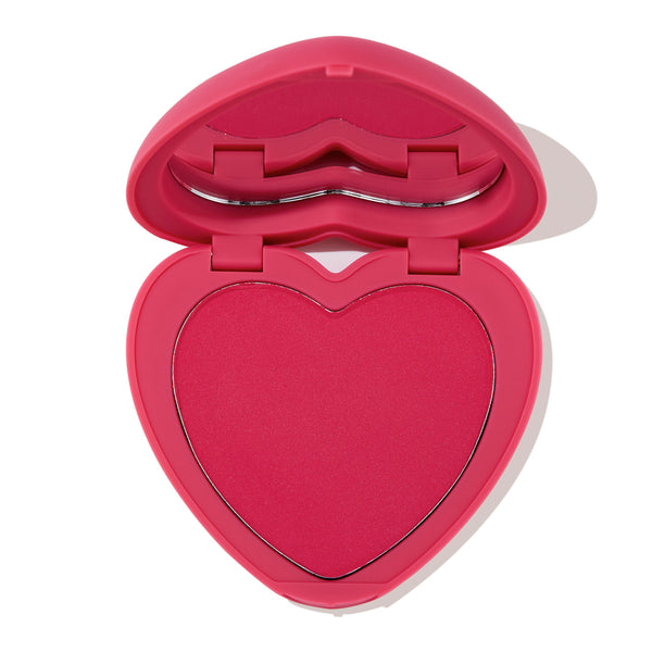 Heart-shaped Text Me pressed powder blush in a bright pink compact, opened to show the vibrant fuchsia pan and lip-shaped mirror, ColourPop Pressed Powder Blush for cheeks displayed on a white background.
