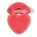 4ever Yours pressed powder blush opens to reveal a heart-shaped pink-coral pan inside a pink compact with built-in mirror on a white background; ColourPop Pressed Powder Blush offering soft, buildable cheek color.